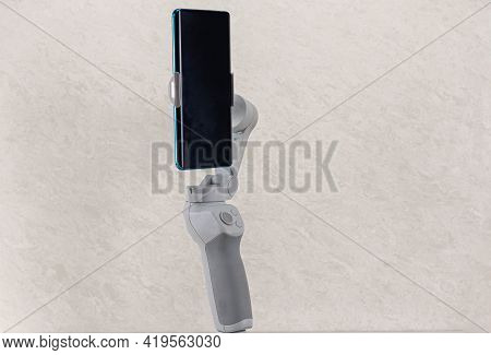 Image Stabilizer Gimbal For Modern Cell Phones. Instrument For Amateur Filming. Image And Video Stab