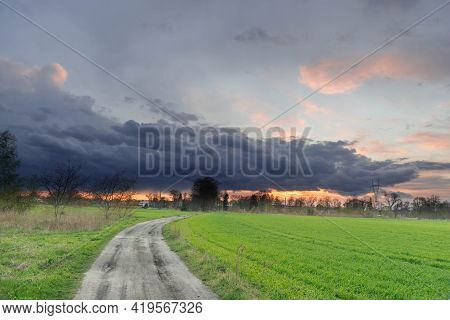 A Vast Plain, Arable Fields And Meadows. It Is Spring In The Fields Growing Young, Green Grain. On T