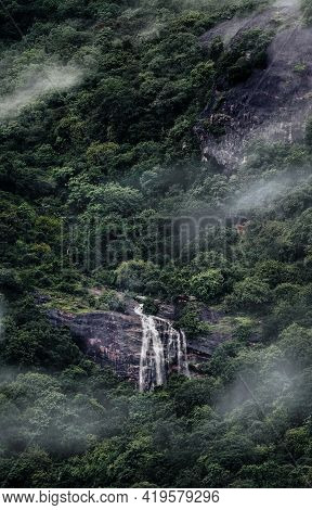 A Waterfall In The Deep Woods On A Cold Mist Covered Day.