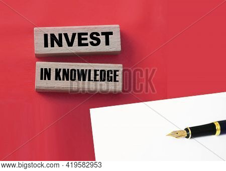 Investing In Knowledge Words On Wooden Blocks. Education Concept.