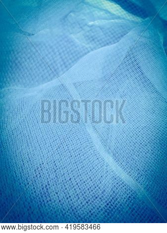 Closeup Of Blue Gauze Material Fabri And Background.