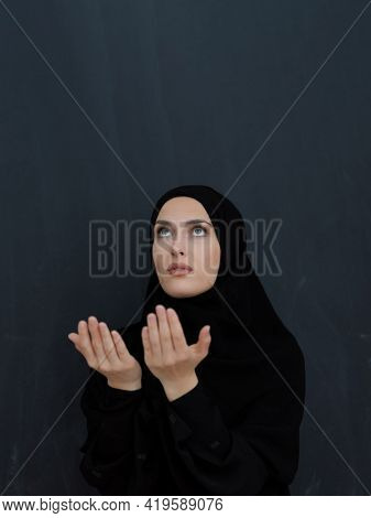 Portrait of young Muslim woman making dua