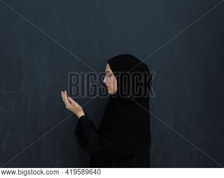 Portrait of young Muslim woman making dua