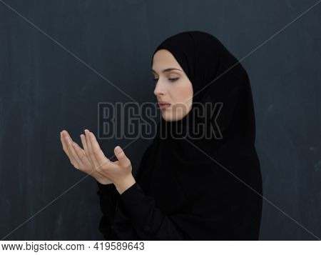 Portrait of young Muslim woman making dua