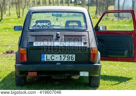 Daugmale, Latvia - May 01, 2021: Colorful Oldtimer Pancars Rental Car Fiat 126 Parked On The Lawn