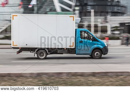 Gazelle Rides On The Road. White And Cyan Cargo Van Gaz Gazelle Next Driving In The Street. Moscow ,