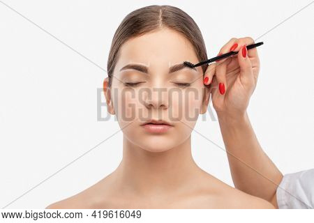 Makeup Artist Combs  And Plucks Eyebrows After Dyeing In A Beauty Salon.professional Makeup And Cosm