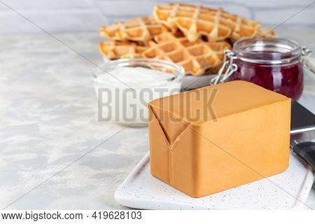 Piece Of Norwegian Brown Cheese With Waffles, Lingon Jam And Cup Of Coffee, Horizontal, Copy  Space