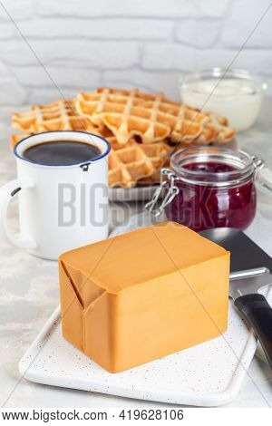 Piece Of Norwegian Brown Cheese With Waffles, Lingon Jam And Cup Of Coffee, Vertical