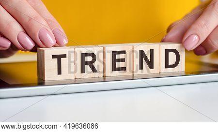 Woman Made Word Trend With Wooden Blocks, Business Concept