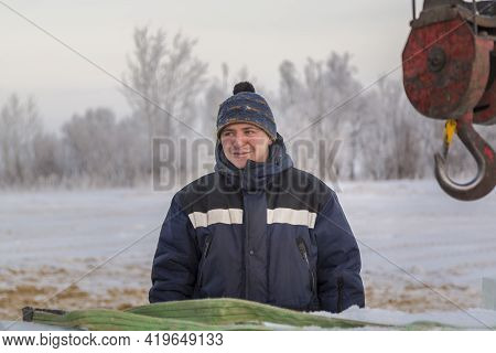 A Portrait Of A Fitter In A Blue Jacket At The Hook