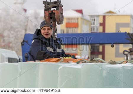 A Portrait Of A Fitter In A Blue Jacket At The Hook