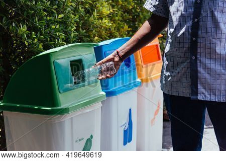 Selective Focus Close Up The Man Black Hand Throwing An Empty Plastic Water Bottle In The Recycling 