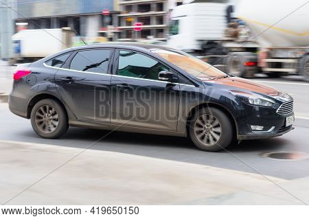 Ford Focus Car On The City Road. Fast Moving Vehicle On Moscow Streets. Side View Of Urban Sedan In 