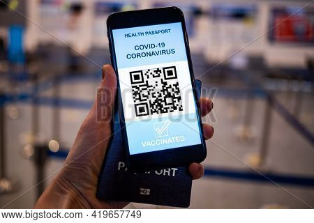 health Vaccine Passport for Coronavirus or Covid-19. Traveller Using Mobile Phone with Vaccination in Immune Status to Certificated International Traveling in Airport
