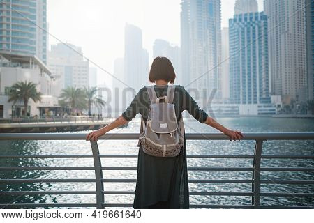 Happy Young Female Traveler In The Big City Of Dubai, Uae