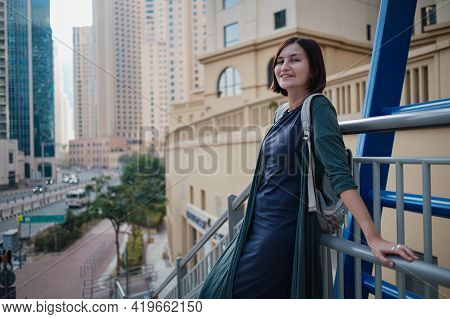 Happy Young Female Traveler In The Big City Of Dubai, Uae
