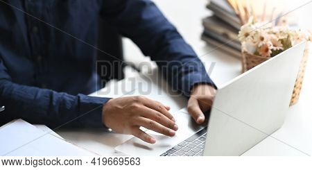 Cropped Image Of Businessman Working With Computer Laptop While Sitting At The White Working Desk Th
