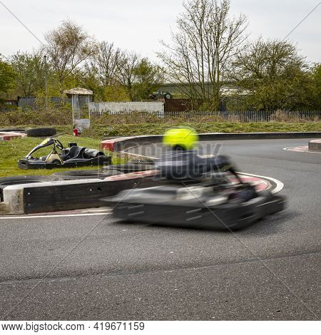 A Shot Of A Racing Kart As It Circuits A Track.