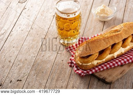 Calamari Rings Sandwich With Beer On Wooden Table. Typica Spanish Food. Copy Space