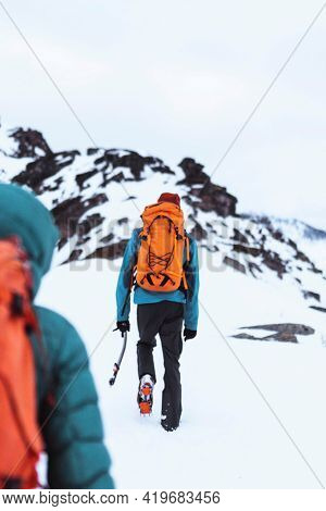 Backpackers hiking up the Segla mountain, Norway