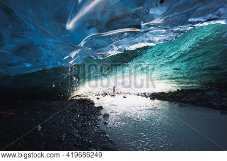 Female explorer in the ice cave, Iceland