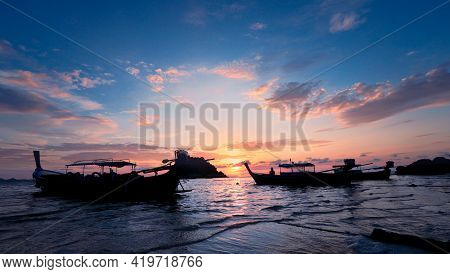 Silhouette Of Wooden Boat In Sea With Sunset And Blue Sky At Lepe Island In Thailand