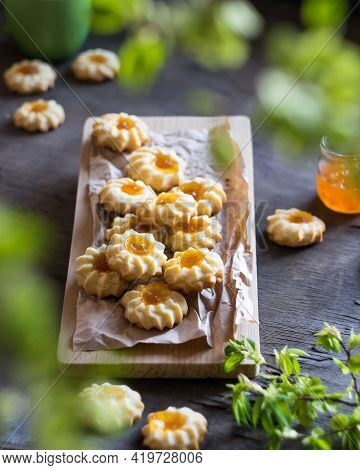 Homemade Shortbread Cookies Qurabiya With Orange Jam In The Center On A Baking Paper On Grey Wooden 
