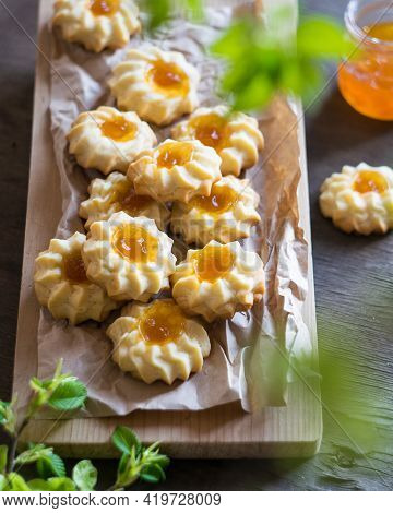 Homemade Shortbread Cookies Qurabiya With Orange Jam In The Center On A Baking Paper On Grey Wooden 
