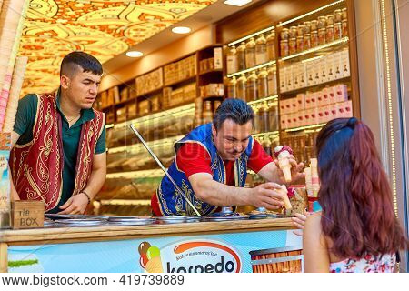 A Turkish Animator, An Ice Cream Seller, Sells Ice Cream To A Girl Hanging Over The Counter. Istanbu