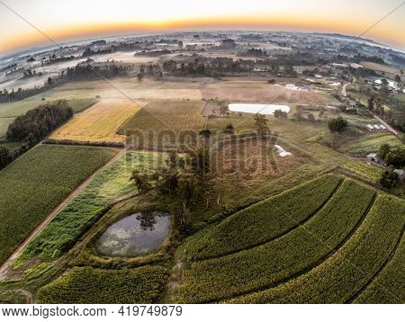 Aerialview With Sunrise With Farm Fields And Fog