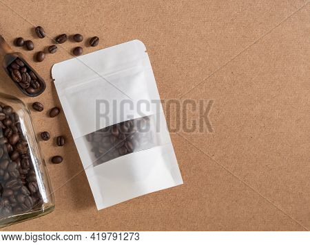 Roasted Coffee Beans In White Transparent Window Paper Bag With Zipper And Wooden Scoop, Glass Bottl