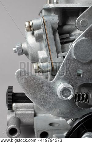 Close Up Of Details Of Car Carburettor Against Gray Background, Small Depth Of Focus. Automotive Par