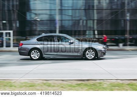 Side View Rolling Shot With Silver Bmw 5 Series F10 F10 Car In Motion. Premium Class Sedan Bmw At Th