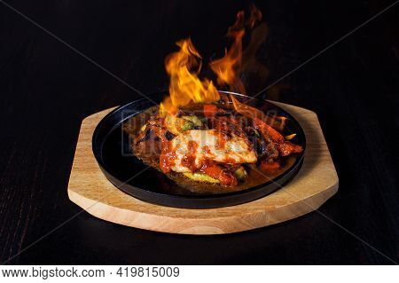 Fajitos, Meat In A Frying Pan With Fire On A Wooden Tray, Beautiful Serving, Dark Background.