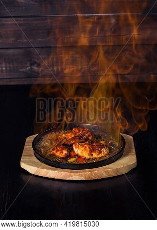 Fajitos, Meat In A Frying Pan With Fire On A Wooden Tray, Beautiful Serving, Dark Background.