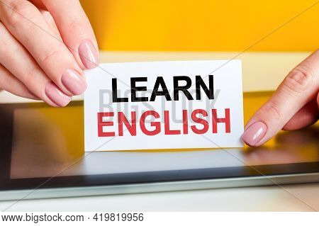 Woman Holds A Piece Of Paper With The Text Learn English, Concept