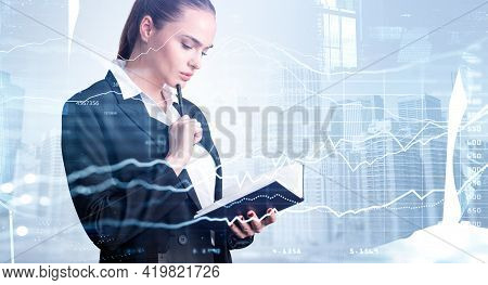 Businesswoman Checking Notes In Notebook. Digital Graph Of Stock Market Changes. Double Exposure Of 