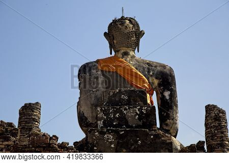Huge Stone Statute Of Buddha Wrapped In Orange Clock Monastry Phonsavan, Laos.