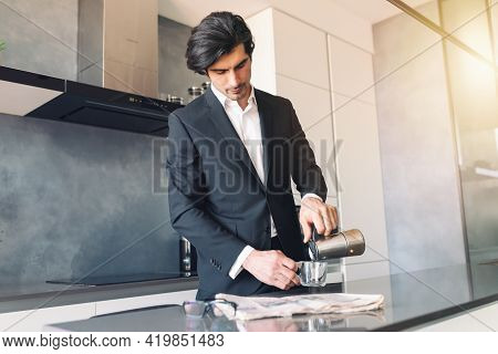 Business Man Drinks A Cup Of Coffee At Her House, While Reading News From The Newspaper