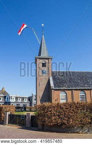 Dutch Flag On The Tower Of The Historic Church In Eernewoude, Netherlands