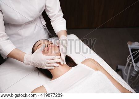 Medical Skincare Treatment. Beauty Clinic Patient Lying Therapy Table, Beautician Doctor Clean Facia