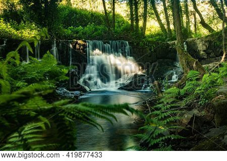 Waterfall Near The River Beach Of Mamoa
