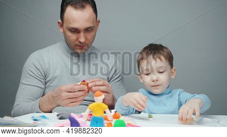 Shooting Of Dad And Little Boy Making Animals From Plasticine