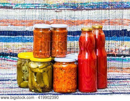 Glass Jars With Pickled Red Bell Peppers And Pickled Cucumbers (pickles) Isolated. Jars With Variety