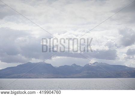 Arran Viewed From Rothesay In Isle Of Bute Under Dark Clouds
