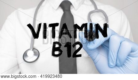 Medicine Concept. Doctor Writes The Word Vitamin B12 . Image Of A Hand Holding A Marker Isolated On