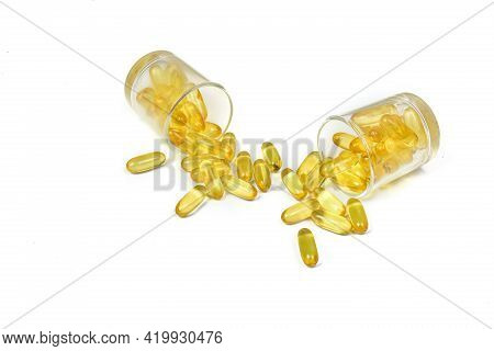 Top View Of Supplementary Food. Gold Fish Oil Isolated For Good Health On White Background. Omega 3.