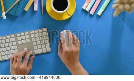 Top View Image Of Hands While Using A Wireless Keyboard And Mouse That Putting On Colorful Working D