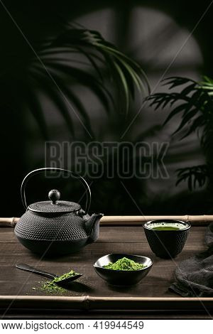 Matcha Tea Powder And Tea Accessories On Dark Wooden Base. Tea Ceremony. Traditional Japanese Drink.